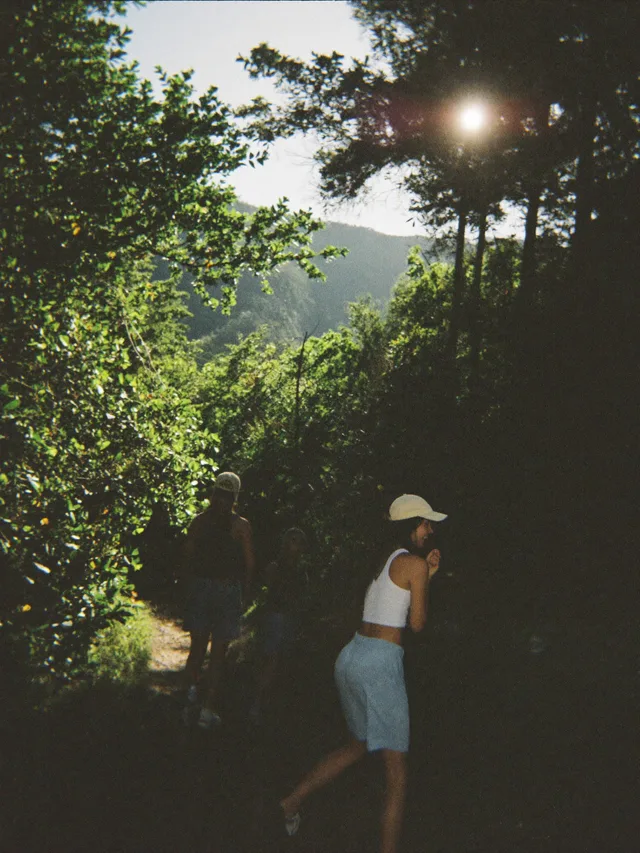 Friends on a green trail in late-afternoon sun