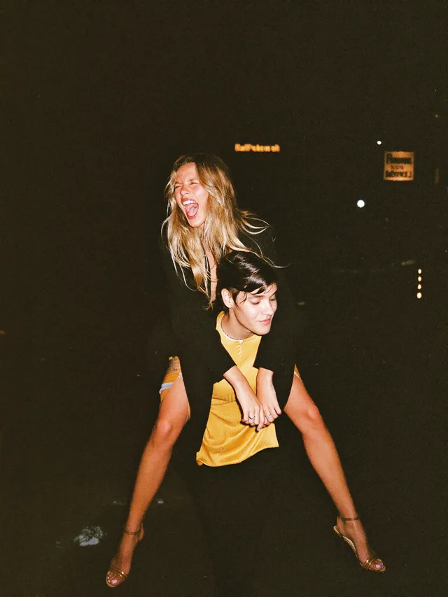 A piggyback ride caught by the flash at night